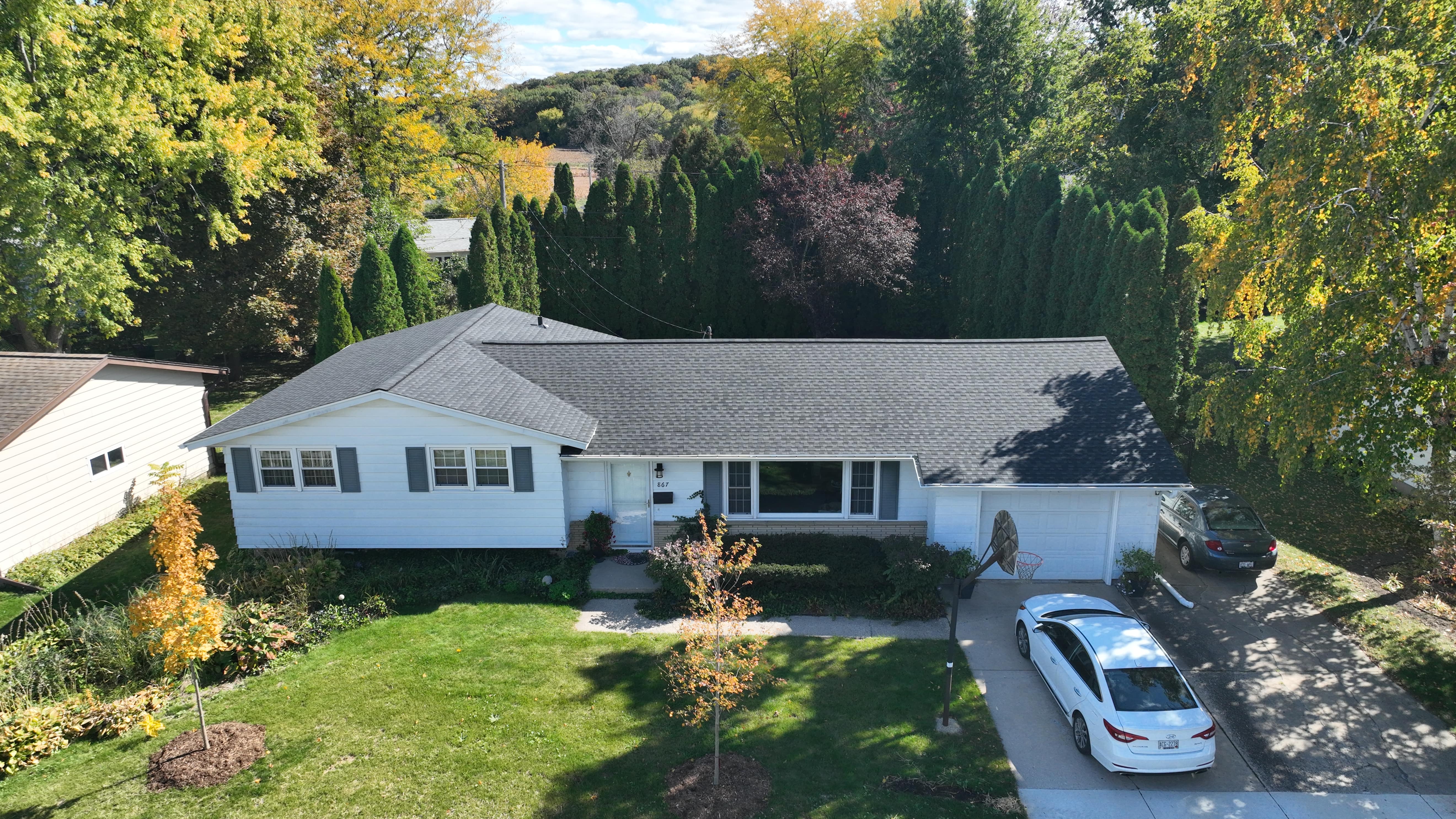 New asphalt shingle roof installed on residential home replacing an aging roof with improved durability and curb appeal