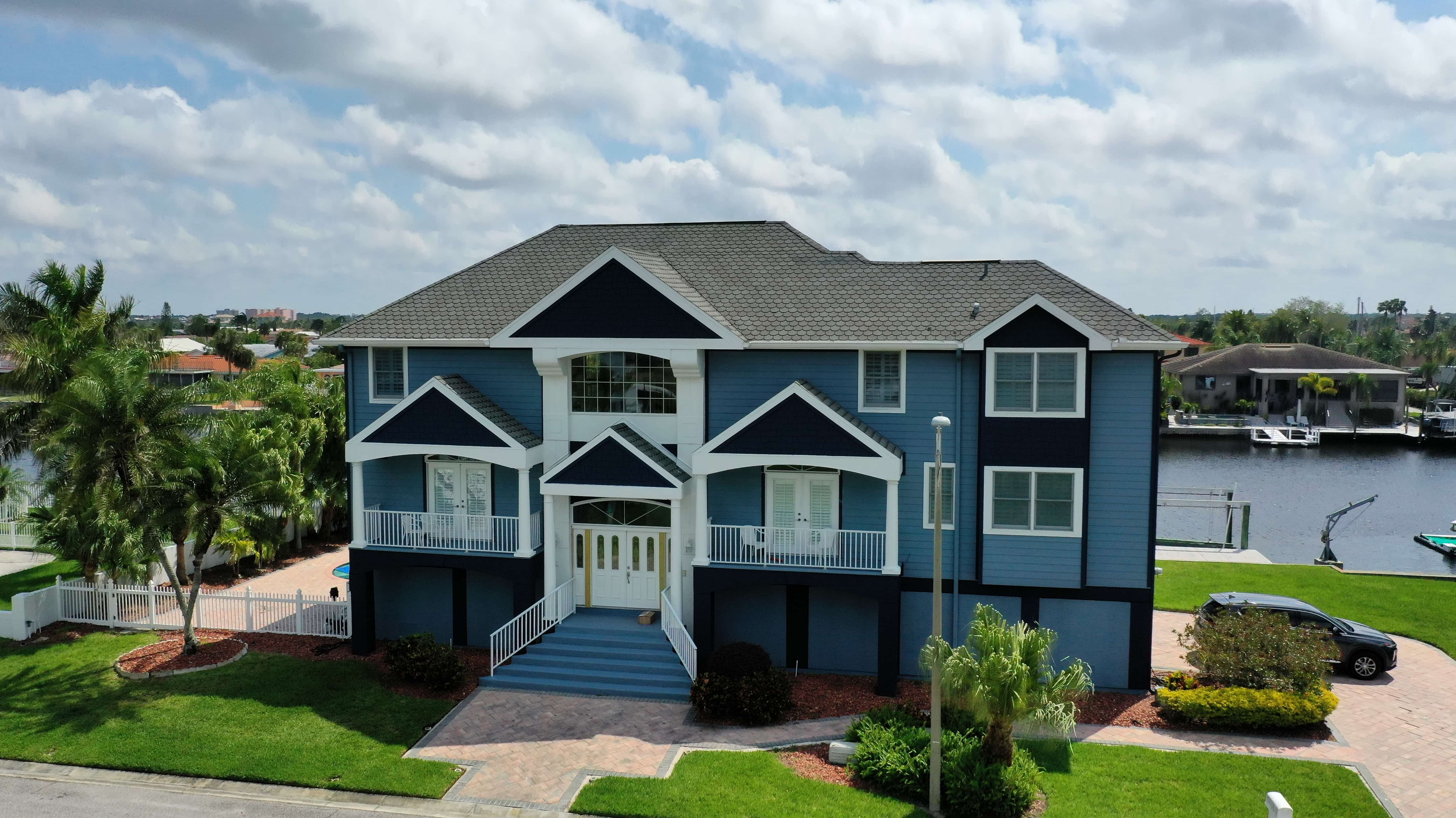 Coastal Florida home with new blue Hardie siding and updated exterior on waterfront canal lot