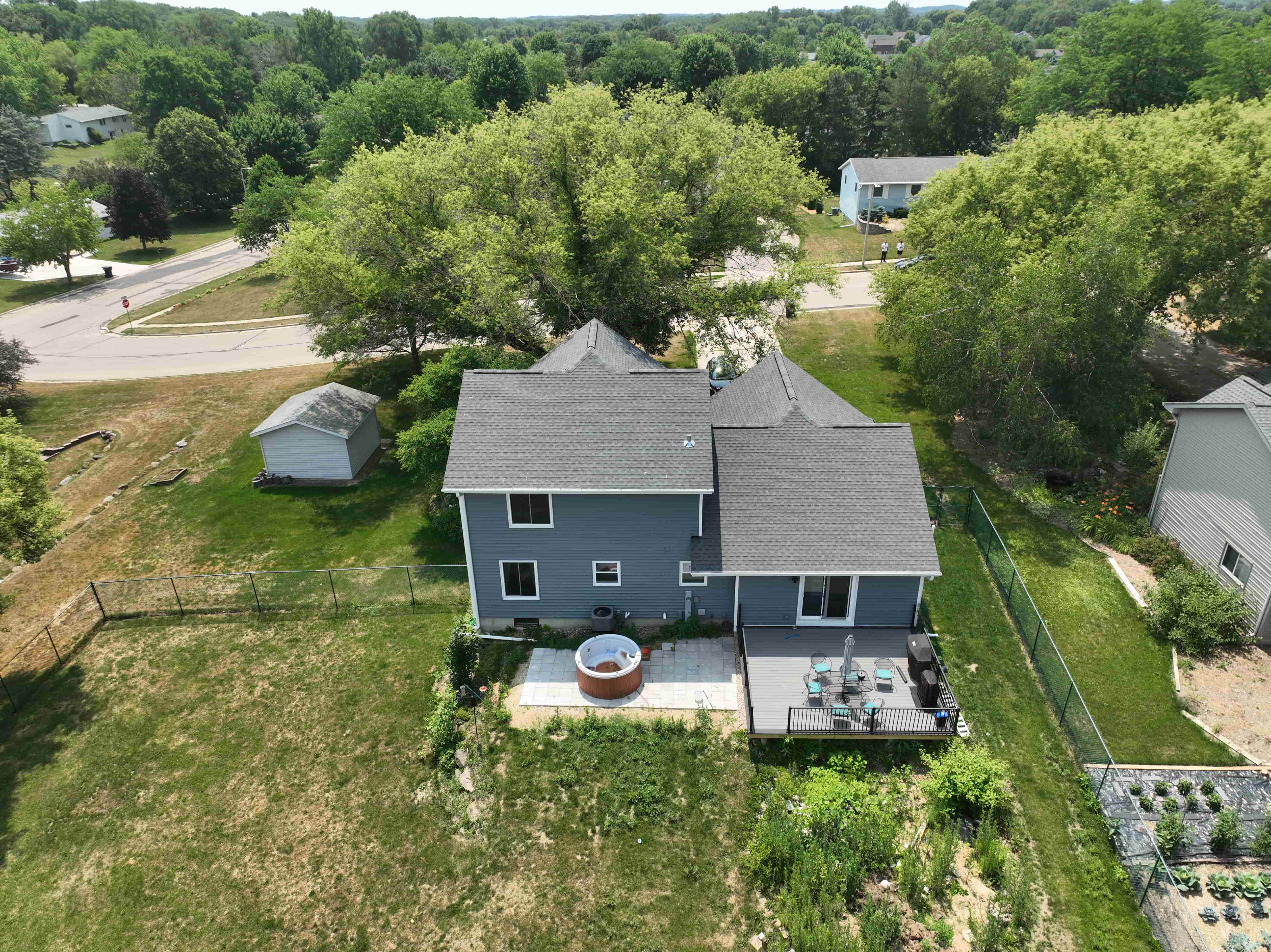 Aerial angle of home highlighting new asphalt shingle roof and clean exterior lines after renovation