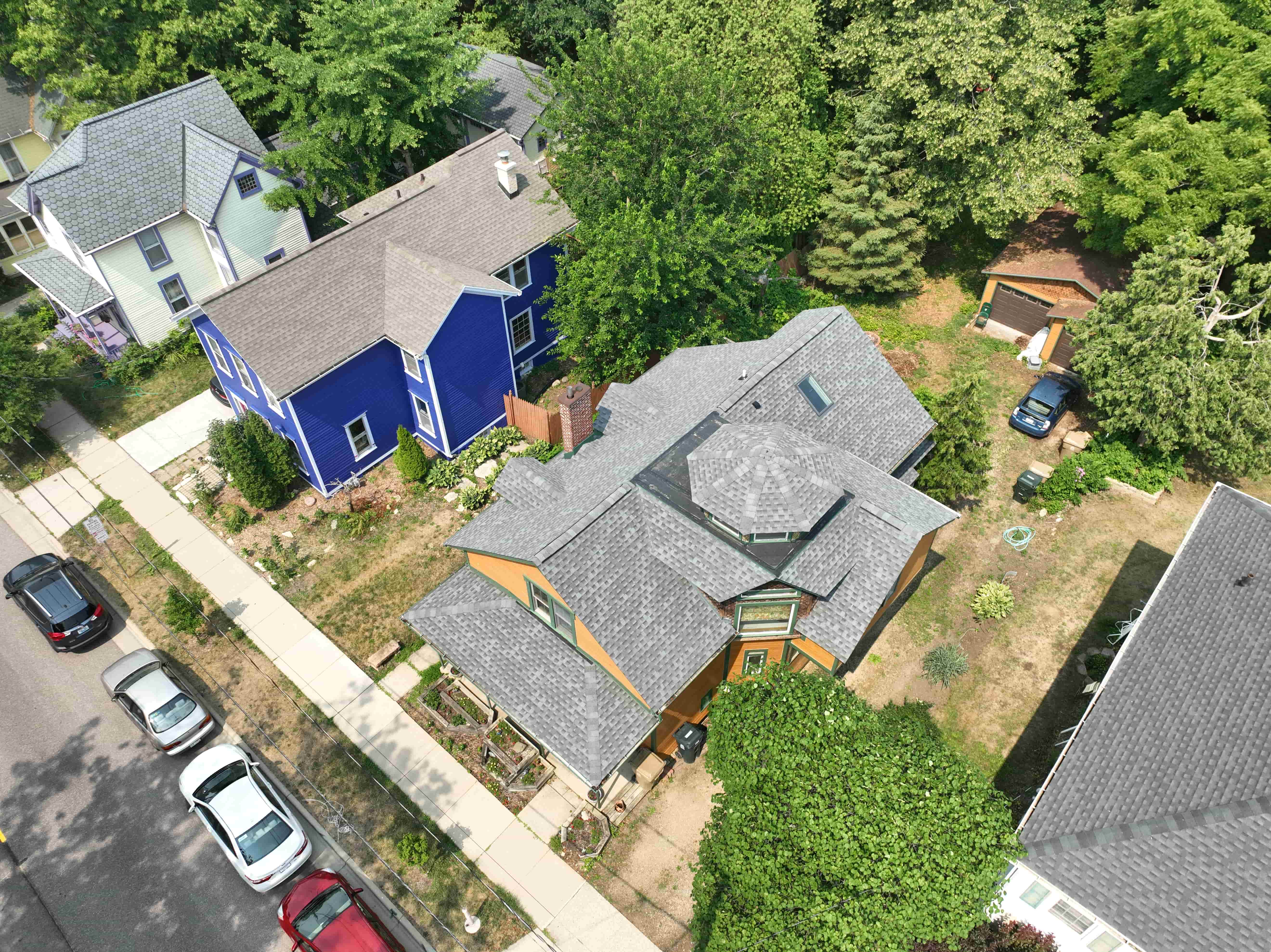 Top-down view of home with newly installed roof showcasing intricate design and seamless shingle integration