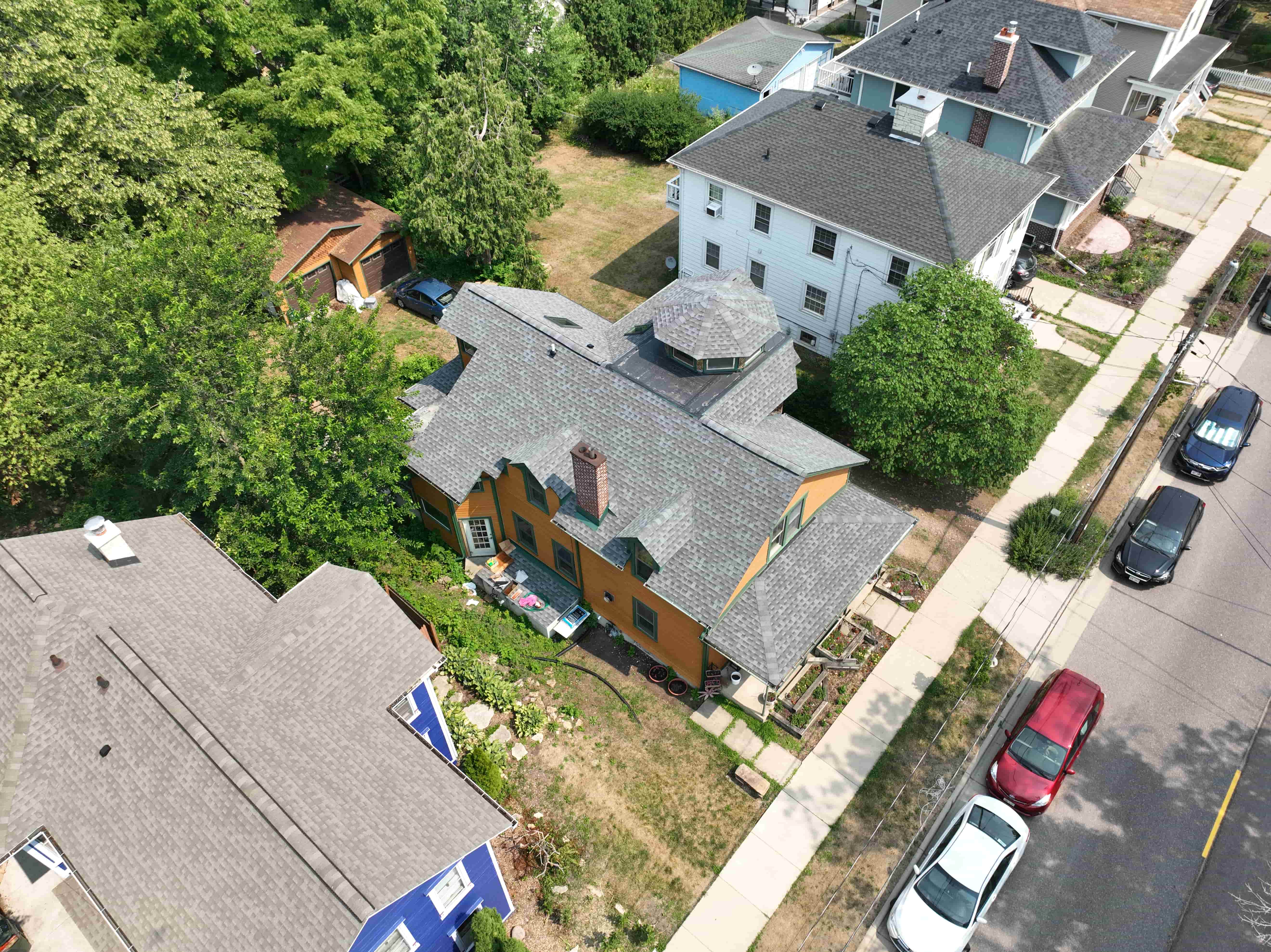 After roof replacement featuring new shingles installed on complex multi-angle roof with clean lines and precise detailing