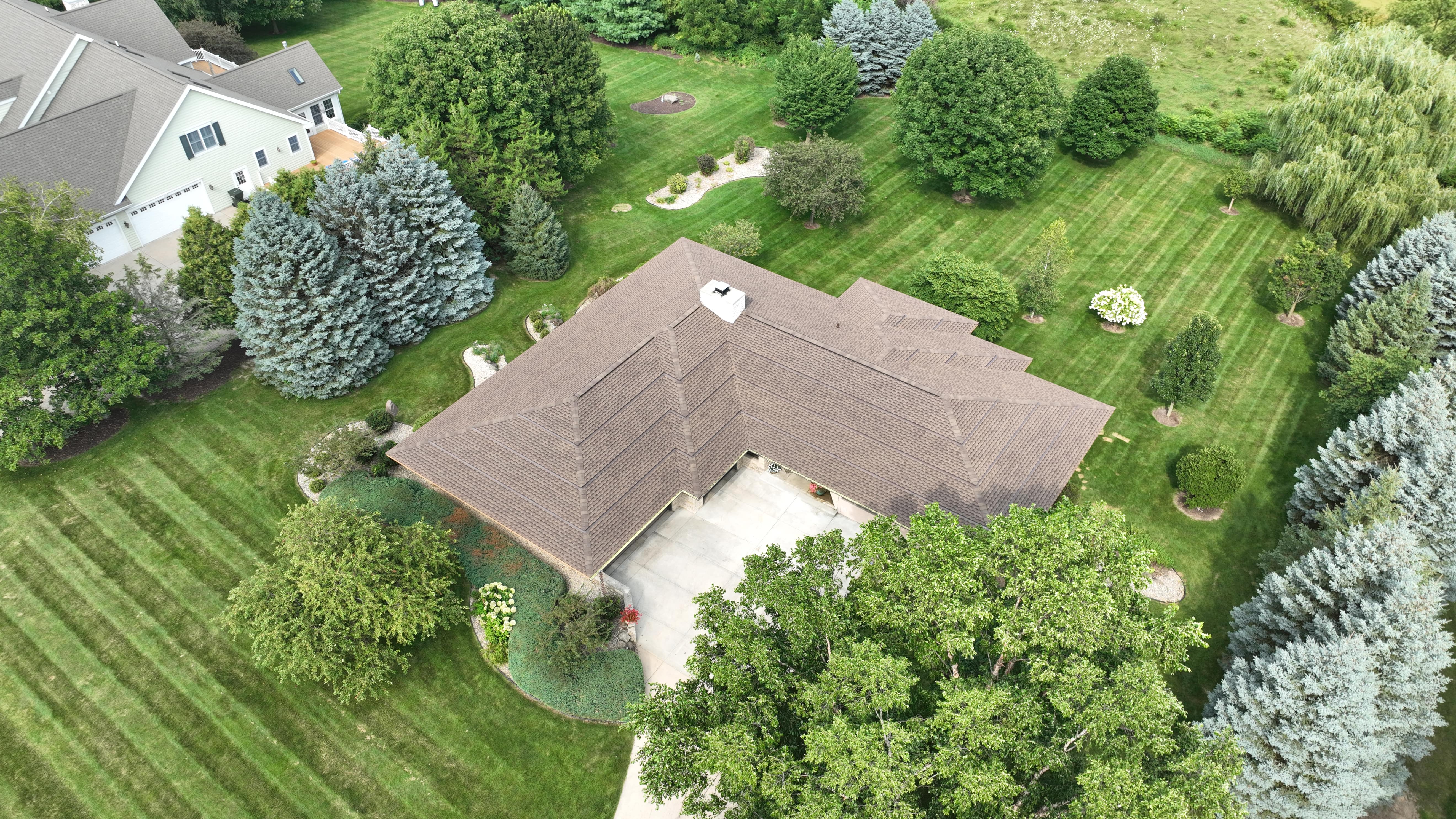 Aerial view of stepped roof in Madison WI with newly installed GAF Weathered Wood shingles highlighting clean lines and precise installation