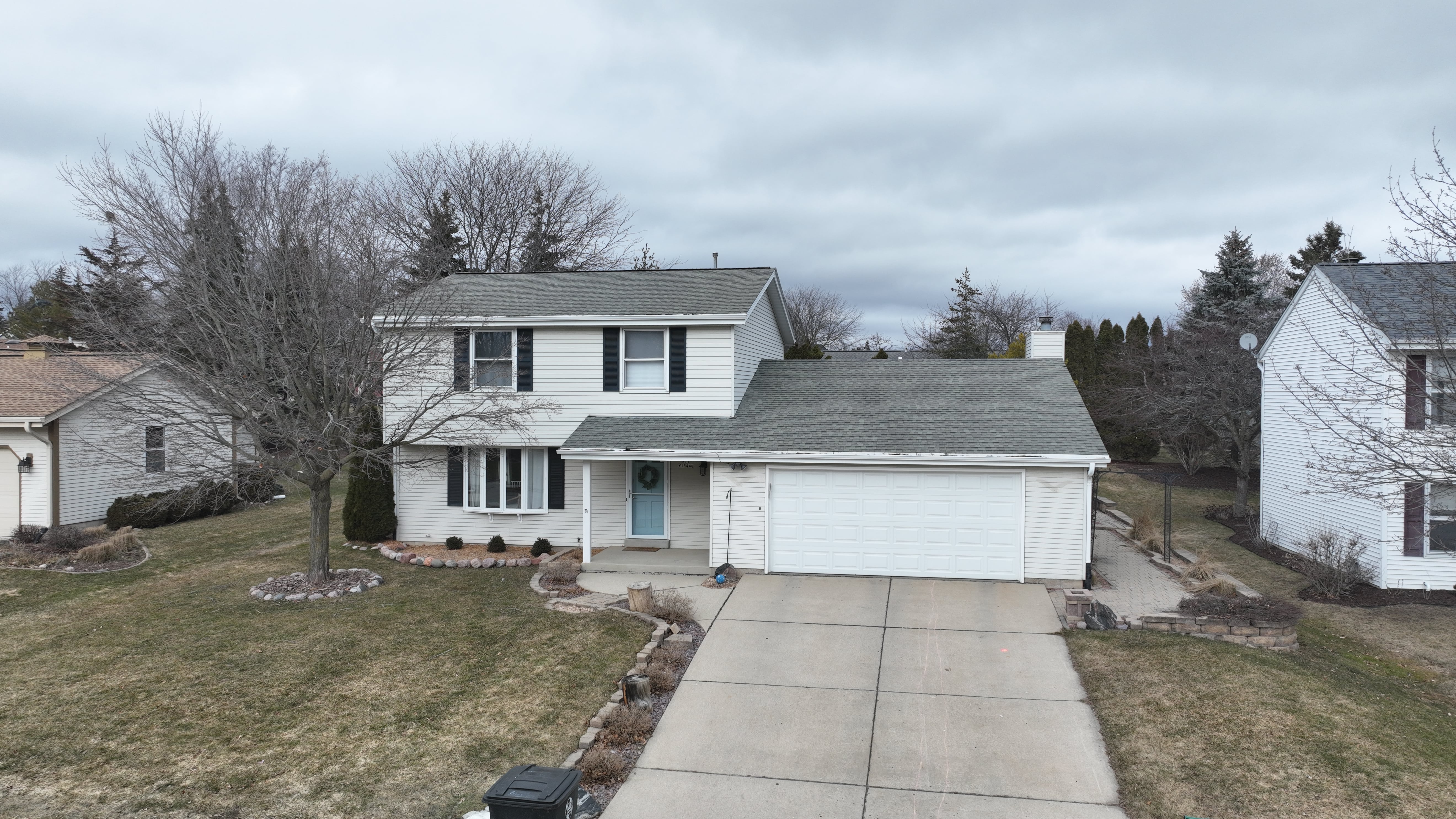 Before siding and gutter replacement in Milwaukee WI showing outdated exterior and aging gutter system