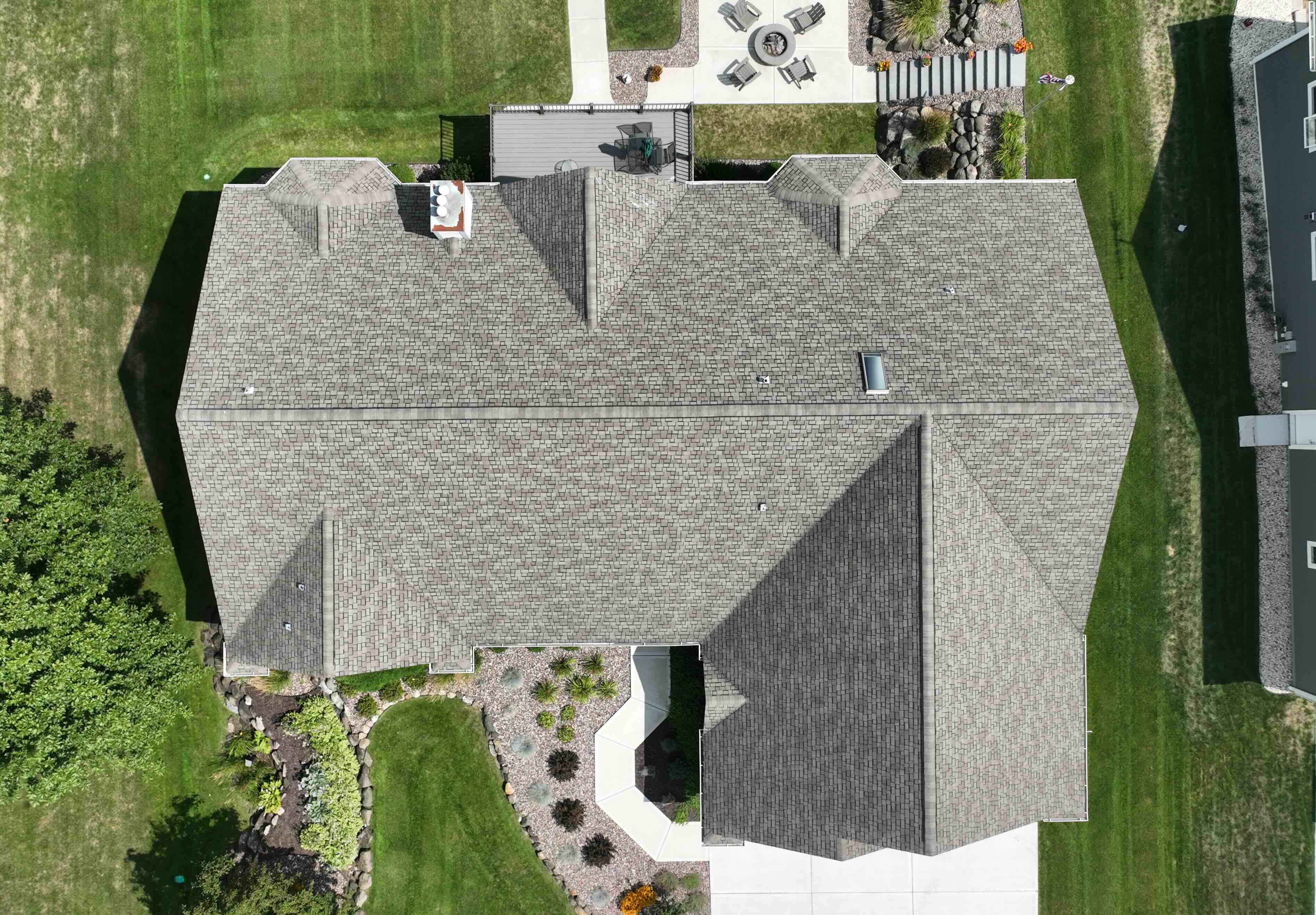 Before roof replacement in Gurnee IL showing aging asphalt shingles and outdated gutter system from aerial top view
