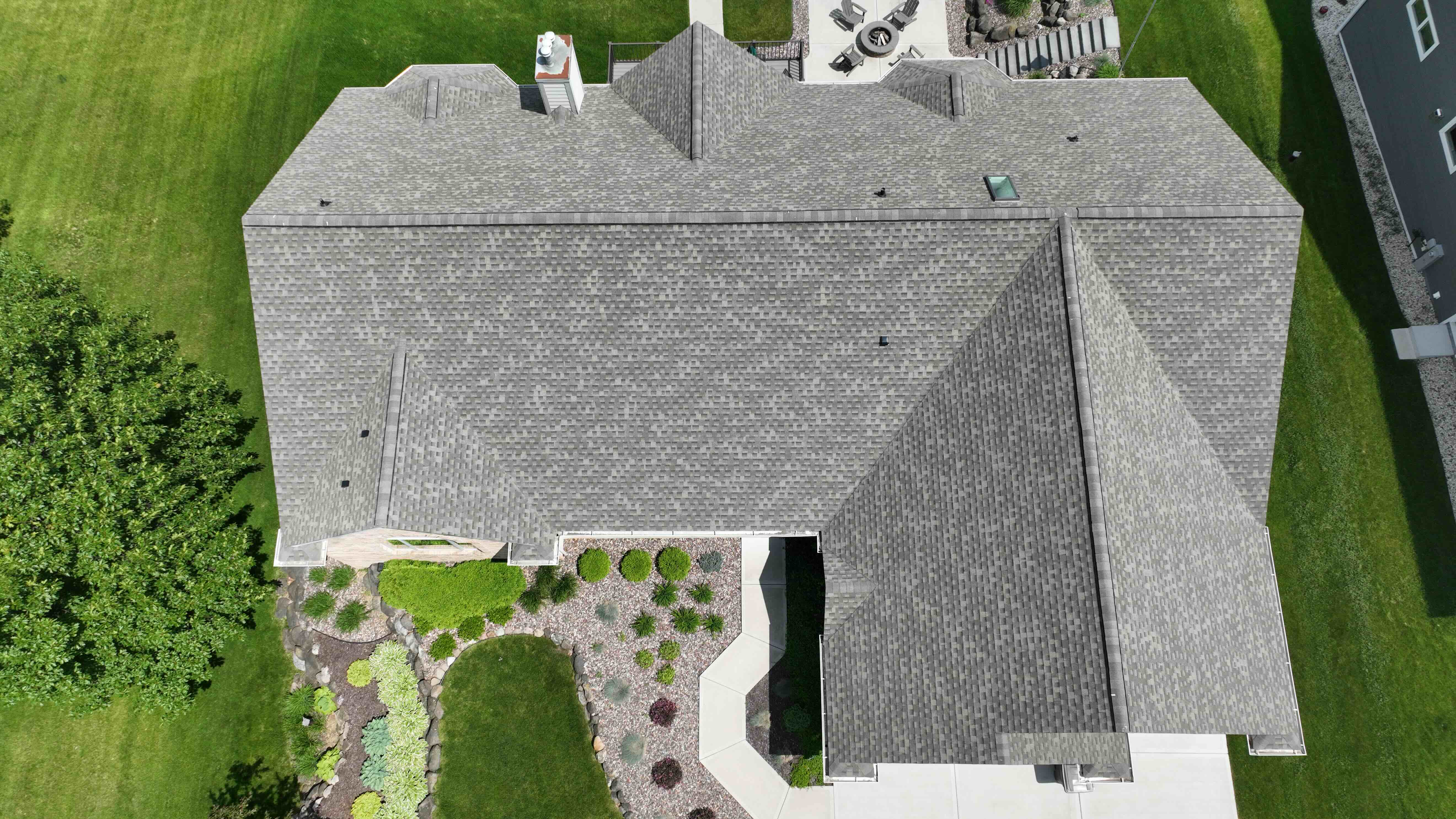 After roof and gutter replacement in Gurnee IL with new GAF asphalt shingles and improved drainage system shown from aerial top view