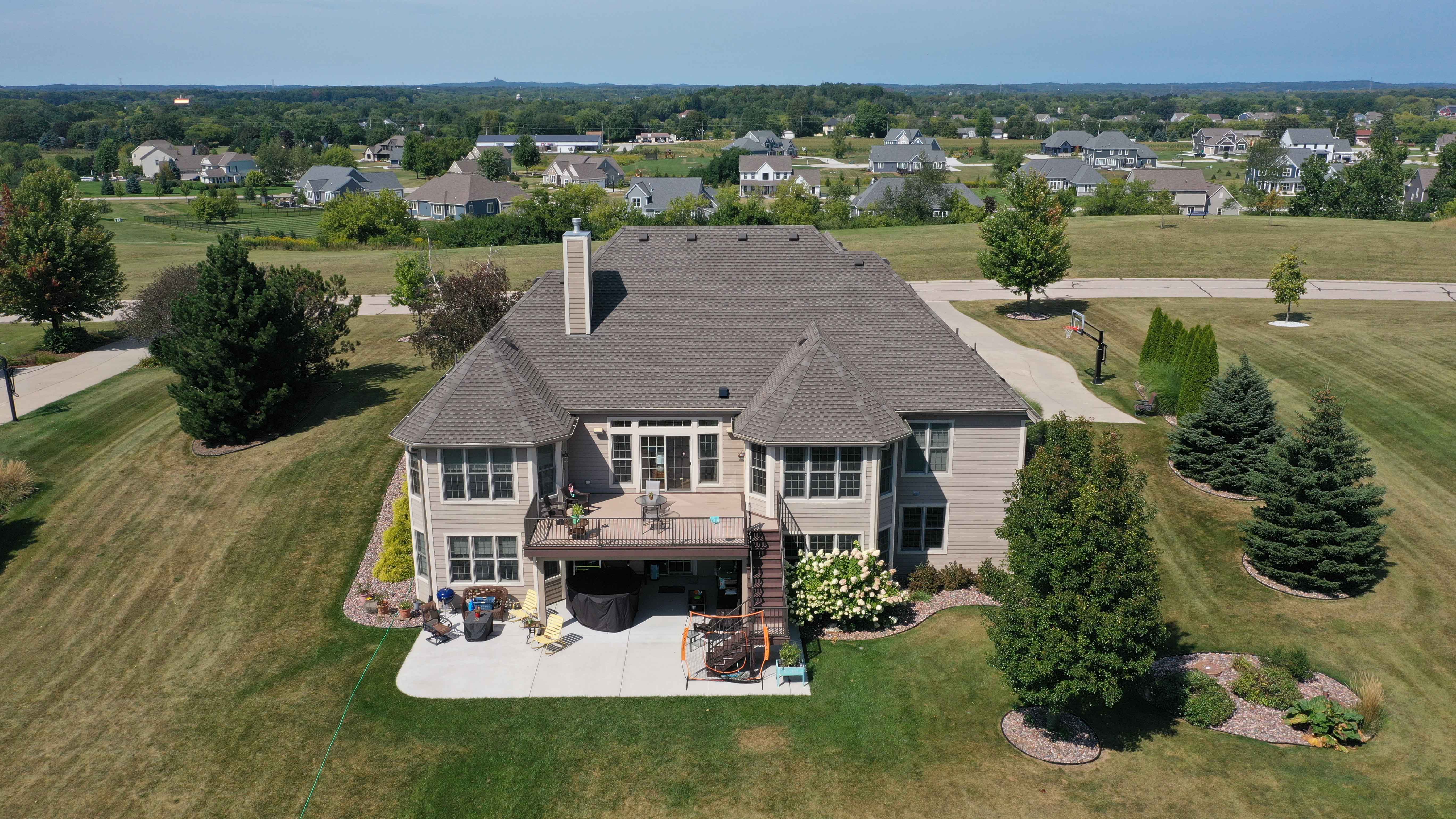 After roof replacement in Milwaukee featuring new architectural asphalt shingles with improved color, structure, and curb appeal